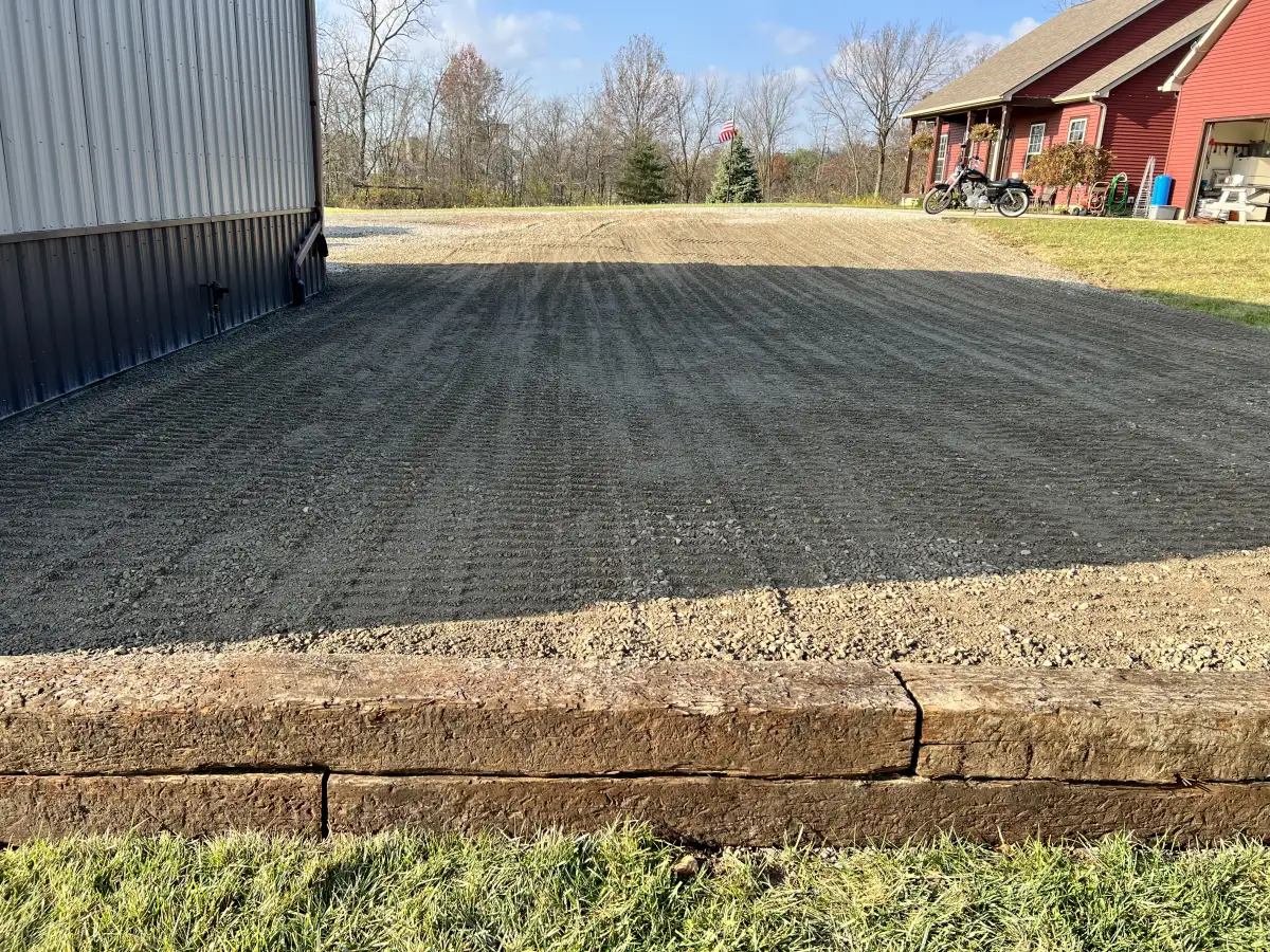 Gravel driveway regrading in progress using skid steer equipment at a rural Ohio property