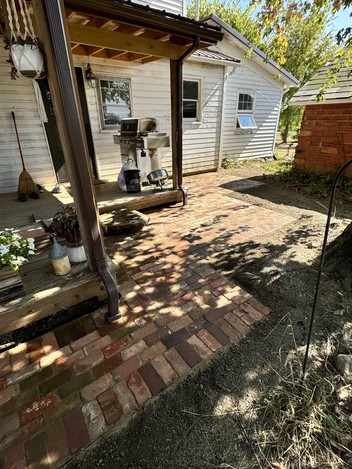Natural stone retaining wall installation at a sloped property in Marysville, Ohio