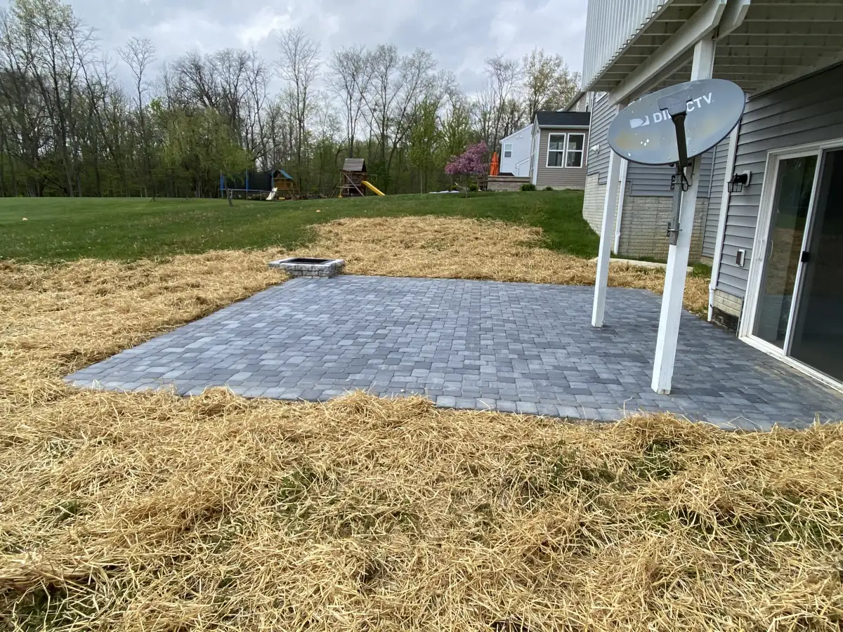 Paver patio installation in progress at a Central Ohio home